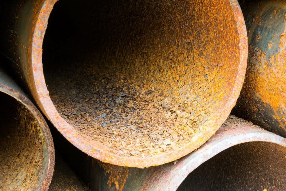 Close up of stacked pipes with internal pipeline corrosion