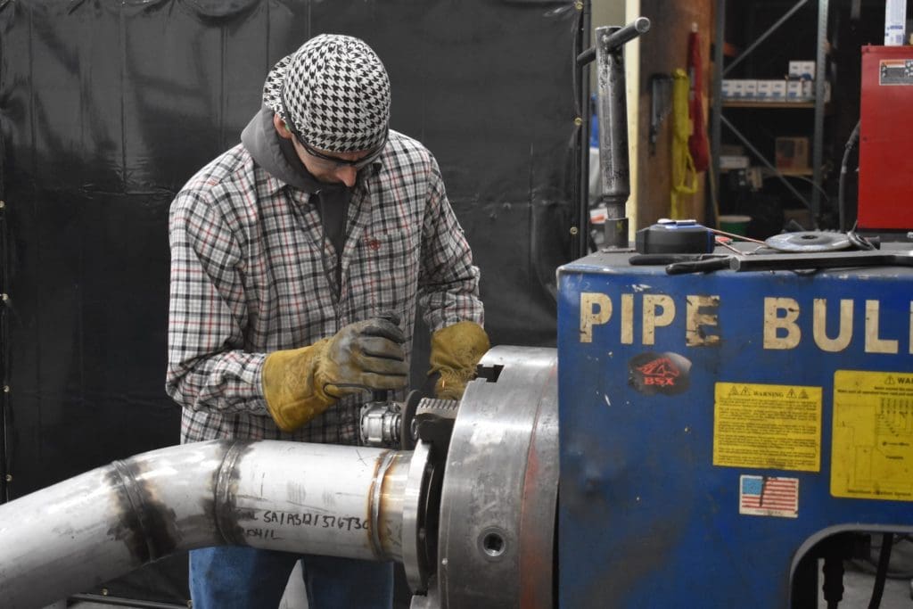 Technician working on pipe